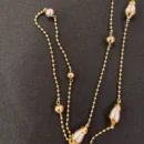jpg136C GOLD LONG CHAIN WITH SMALL GOLD BALLS MEDIUM GOLD AND SILVER BALLS AND SILVER OVAL IN GOLD scaled